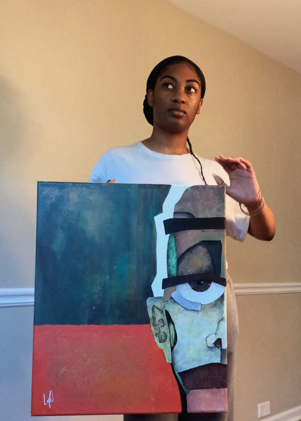 Abstract Original Painting totled "Closer" Image of artist holding original painting in right hand. Painting is half of an abstract face in the right side of the canvas colors; orange,green, yellow, browns, and greens
